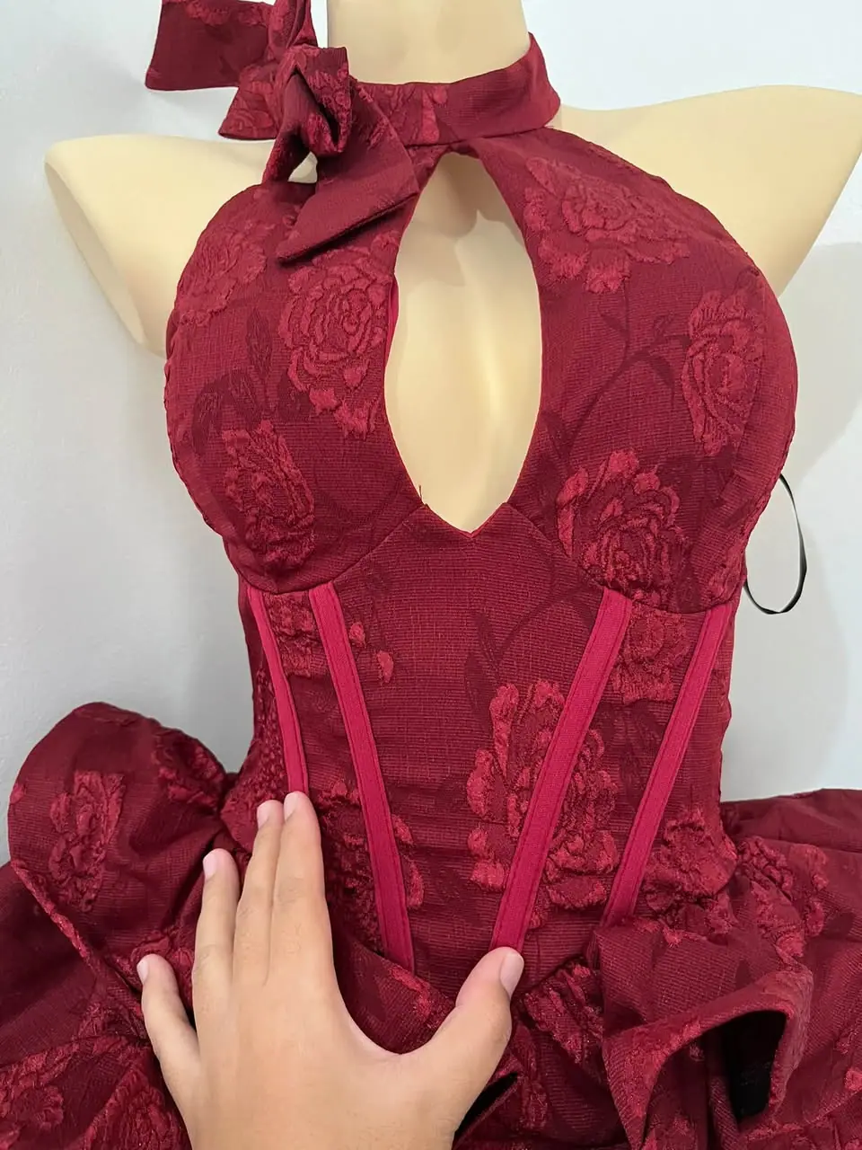 A closer view of Rose’s floral bodice and bow halter neckline